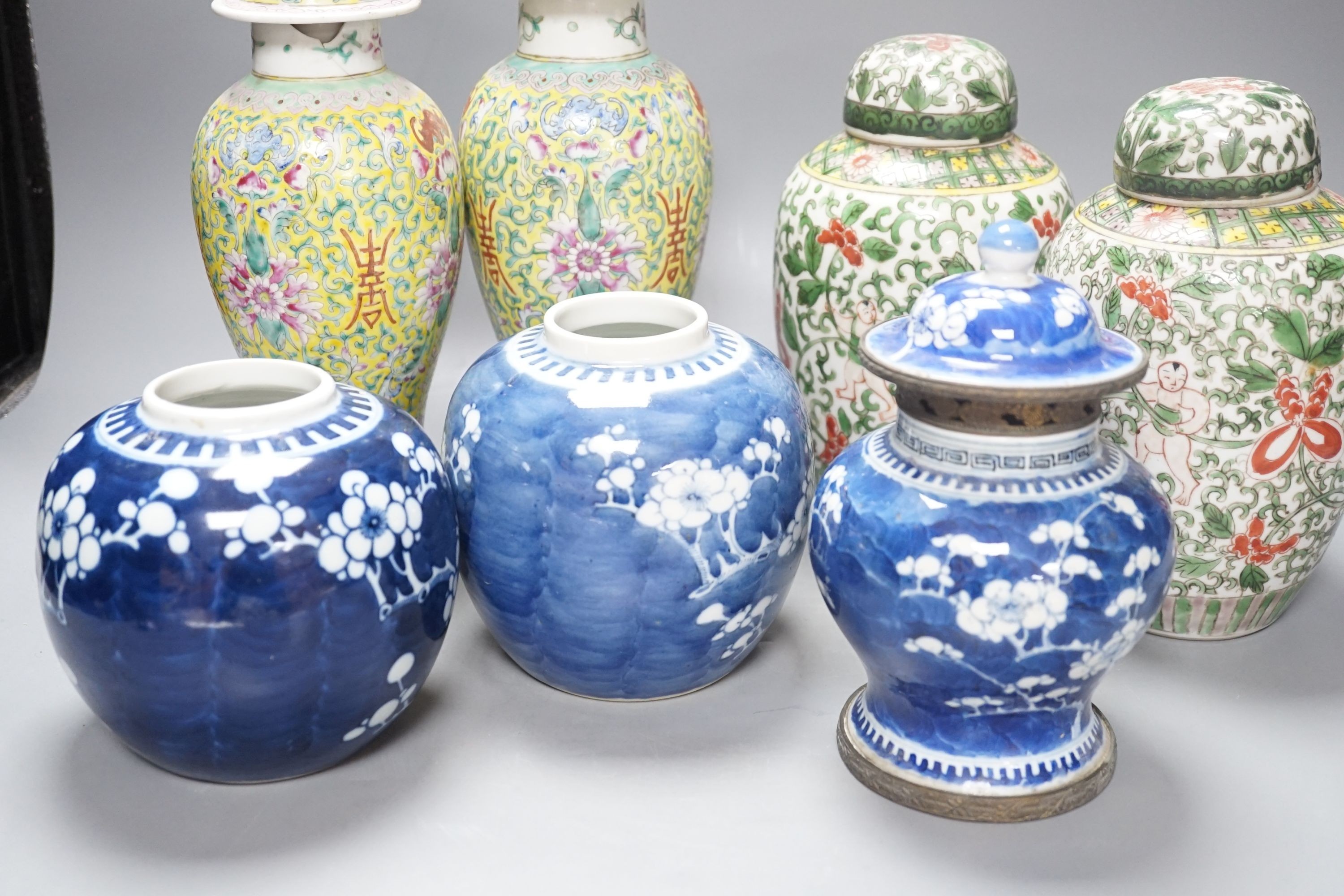 A pair of Chinese porcelain vases and covers, a pair of jars and covers, a metal mounted vase and cover and two prunus jars, (7), Tallest vases 26.5 cms high including cover.